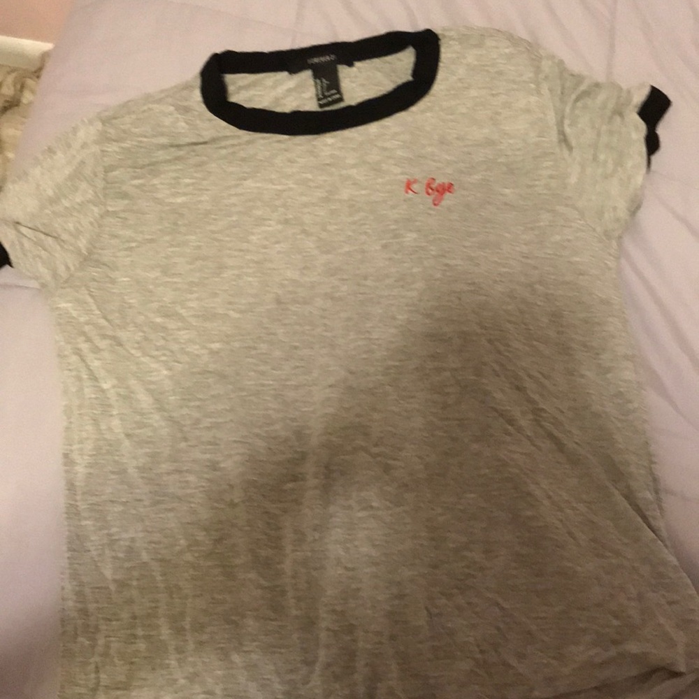 Grey graphic tea shirt with writing on it